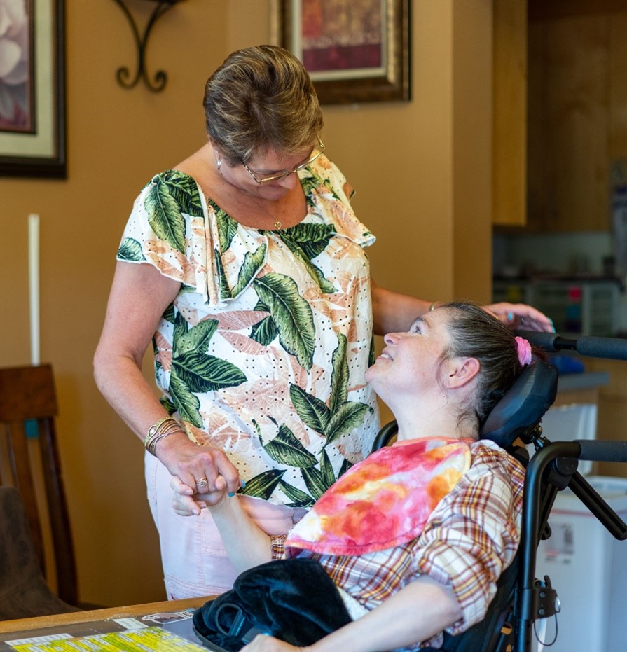 A woman caring for person in a wheelchair